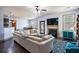 Open concept floor plan with a living room, kitchen, and dining area; features a cozy fireplace at 2195 Well Springs Dr, Buford, GA 30519