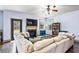 Bright living room with fireplace, large sectional sofa, backyard access, and built-in bookshelves at 2195 Well Springs Dr, Buford, GA 30519