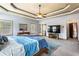 Expansive main bedroom with a tray ceiling, large windows, and a glimpse into the ensuite bathroom at 2195 Well Springs Dr, Buford, GA 30519
