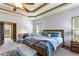 Comfortable main bedroom featuring a cozy bed, ceiling fan, and ample natural light from the windows at 2195 Well Springs Dr, Buford, GA 30519