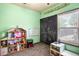 Bright playroom featuring a chalkboard wall, dollhouse, and organized storage, perfect for creative play at 2195 Well Springs Dr, Buford, GA 30519