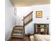 Inviting staircase with hardwood floors, carpeted steps, and decorative iron railings, blending style and safety at 2195 Well Springs Dr, Buford, GA 30519