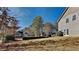 Residential backyard featuring an expansive lawn and a view of neighboring homes on a sunny day at 3245 Country Walk Dr, Powder Springs, GA 30127