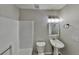 Bright, clean bathroom with white fixtures, a pedestal sink, and a shower-tub combo at 3245 Country Walk Dr, Powder Springs, GA 30127