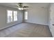 Bedroom with neutral carpet, two windows for plenty of light, ceiling fan, and closet at 3245 Country Walk Dr, Powder Springs, GA 30127