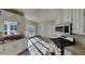 Kitchen featuring granite counters, stainless steel appliances, white cabinets, and ample natural light at 3245 Country Walk Dr, Powder Springs, GA 30127