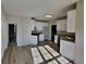 Open kitchen with stainless steel appliances, granite counters, white cabinets, and new laminate floors at 3245 Country Walk Dr, Powder Springs, GA 30127