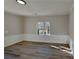 The room features wood-look flooring, white wainscoting, and a large window providing natural light at 3245 Country Walk Dr, Powder Springs, GA 30127