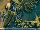 Aerial shot showing homes surrounded by trees and a mix of green and brown fields at 3526 Highway 11 S, Mansfield, GA 30055