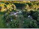 Expansive aerial view of a home nestled among lush greenery and mature trees in a rural setting at 3526 Highway 11 S, Mansfield, GA 30055
