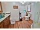 Practical bathroom layout with wood-look flooring, a vanity, and a combined shower/laundry area at 3526 Highway 11 S, Mansfield, GA 30055