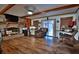 Cozy living room with a brick fireplace, wood floors, and a comfortable seating area at 3526 Highway 11 S, Mansfield, GA 30055