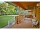 Cozy porch with seating, a ceiling fan, and a view of the beautiful yard at 3526 Highway 11 S, Mansfield, GA 30055