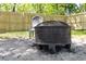 Backyard with new wooden fence, a metal fire pit, and an Adirondack chair for relaxing outdoors at 514 English Nw Ave, Atlanta, GA 30318