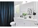 Stylish bathroom with double vanity, black fixtures, and a modern navy shower curtain at 514 English Nw Ave, Atlanta, GA 30318