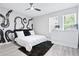 Modern bedroom featuring unique wall art, a ceiling fan, and a light wood floor at 514 English Nw Ave, Atlanta, GA 30318