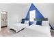 Comfortable bedroom with two twin beds, designer accent wall, and bright natural light at 514 English Nw Ave, Atlanta, GA 30318