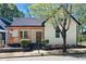 Charming home featuring a covered porch, complemented by manicured landscaping and a lovely tree at 514 English Nw Ave, Atlanta, GA 30318