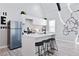 Modern kitchen featuring white cabinetry, stainless steel appliances, and a stylish breakfast bar at 514 English Nw Ave, Atlanta, GA 30318
