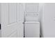 Efficient laundry area featuring a stacked washer and dryer unit next to a door at 514 English Nw Ave, Atlanta, GA 30318