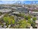 Aerial view of homes with mature trees, city skyline, and residential neighborhood at 650 Somerset Ne Ter, Atlanta, GA 30306