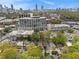 An aerial view of the neighborhood showcasing lush trees, nearby Atlanta skyline, and beautiful homes at 650 Somerset Ne Ter, Atlanta, GA 30306
