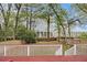 A spacious backyard featuring a white picket fence, green grass, and nearby tall buildings at 650 Somerset Ne Ter, Atlanta, GA 30306