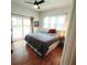 Cozy bedroom featuring hardwood floors, a ceiling fan, and a door leading to the outdoor deck at 650 Somerset Ne Ter, Atlanta, GA 30306