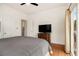 Bedroom with hardwood floors, a large TV on a dresser, and a sliding glass door to the outside at 650 Somerset Ne Ter, Atlanta, GA 30306