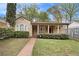 Inviting bungalow with landscaped front yard, brick pathway, and charming covered porch at 650 Somerset Ne Ter, Atlanta, GA 30306