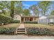 Charming single-story home featuring a brick walkway, red door, and lush landscaping at 650 Somerset Ne Ter, Atlanta, GA 30306