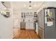 Well-lit kitchen featuring white cabinets, stainless steel appliances, and hardwood floors at 650 Somerset Ne Ter, Atlanta, GA 30306