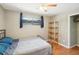 A cozy bedroom with hardwood floors, a ceiling fan, and a large window provides natural light at 1355 Euclid Ne Ave # B24, Atlanta, GA 30307