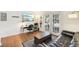 Bright living room with a workspace, hardwood floors, French doors to the balcony and a sleek black sofa at 1355 Euclid Ne Ave # B24, Atlanta, GA 30307