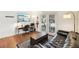Living room with hardwood floors, sofa, desk, and French doors to balcony at 1355 Euclid Ne Ave # B24, Atlanta, GA 30307