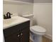 Cozy bathroom featuring tile flooring, white toilet, and a dark vanity with a sink at 136 Peachtree Memorial Nw Dr # Ga8, Atlanta, GA 30309