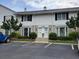 Charming townhouse exterior with stone accents, well-manicured landscaping, and convenient parking at 136 Peachtree Memorial Nw Dr # Ga8, Atlanta, GA 30309