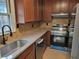 Well-lit kitchen featuring stainless steel appliances, granite countertops, and ample cabinet space at 136 Peachtree Memorial Nw Dr # Ga8, Atlanta, GA 30309