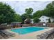 Community swimming pool with lounge chairs and mature trees providing shade at 136 Peachtree Memorial Nw Dr # Ga8, Atlanta, GA 30309