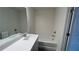 Bathroom featuring a bathtub, white countertop sink, and wood-look floors for a modern design at 36 S Auburn Landing Pl, Auburn, GA 30011