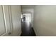 A hallway leading to an open kitchen with modern appliances at 36 S Auburn Landing Pl, Auburn, GA 30011