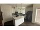Modern kitchen with white cabinets, stainless appliances, and an island at 36 S Auburn Landing Pl, Auburn, GA 30011