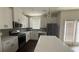 Bright kitchen featuring white cabinets, an island and stainless steel appliances at 36 S Auburn Landing Pl, Auburn, GA 30011