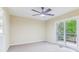Bright bedroom with large sliding glass door to deck, ceiling fan and neutral carpet flooring at 746 Polk Nw St, Marietta, GA 30064
