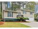 Inviting two-story home featuring a two-car garage, well-maintained lawn, and charming curb appeal at 746 Polk Nw St, Marietta, GA 30064