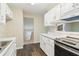 Bright kitchen with stainless steel appliances, white cabinetry, granite countertops, and wood flooring at 746 Polk Nw St, Marietta, GA 30064