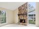 Cozy living room showcasing a stone fireplace with large windows, providing an abundance of natural light at 746 Polk Nw St, Marietta, GA 30064
