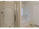 Bathroom with glass door shower and separate tub, featuring tiled floors at 9061 Jim Purcell Dr, Covington, GA 30014