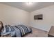 Bedroom with carpeted floors features a television, full sized bed, and neutral-colored walls at 9061 Jim Purcell Dr, Covington, GA 30014
