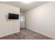 This bedroom features neutral walls, carpet floors and a mounted television at 9061 Jim Purcell Dr, Covington, GA 30014